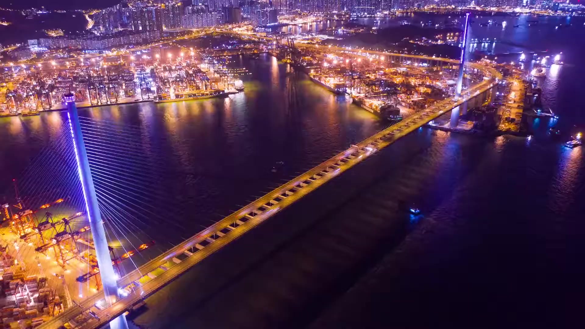 A sweeping aerial panoramic view of a massive deep-sea container terminal at sunset. Thousands of brightly colored metal shipping containers are stacked in geometric rows, while massive gantry cranes loom over industrial transport ships. The warm golden light of the setting sun glints off the water and the metal surfaces, creating a high-contrast industrial premium aesthetic with deep blue shadows and orange highlights.